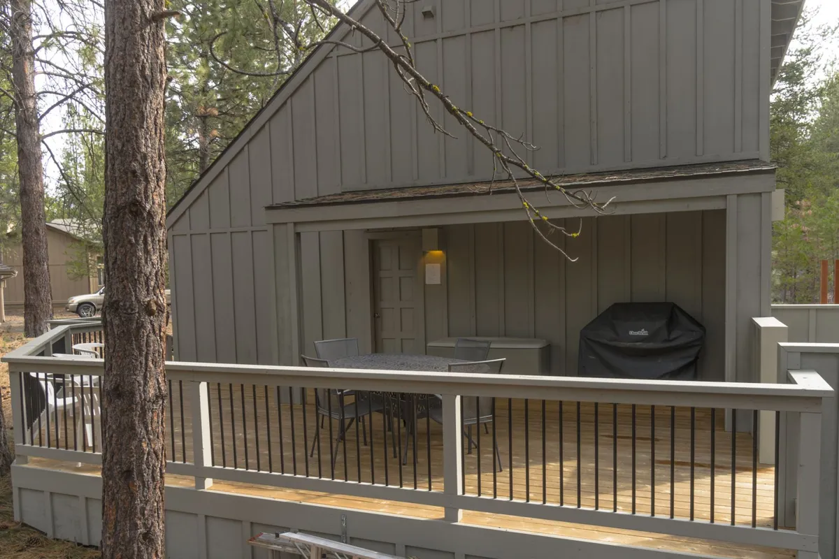 This image features a deck area equipped with a grill and a comfortable dining set, perfect for outdoor dining, relaxing, and social gatherings. The scene captures the relaxed and communal mood that is ideal for family adventures and unwinding after an active day.